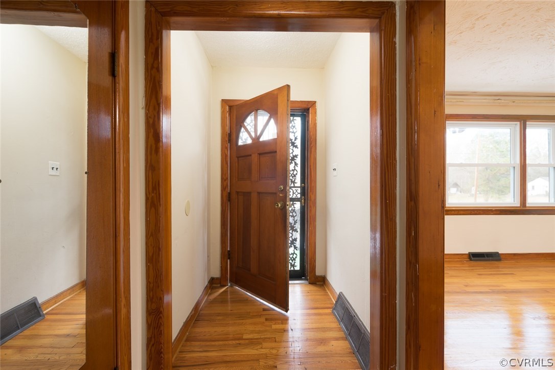 11413 Reedy Branch Road Chesterfield, VA 23838 - Photo 7 of 25 a view of a hallway with wooden floor and a living room