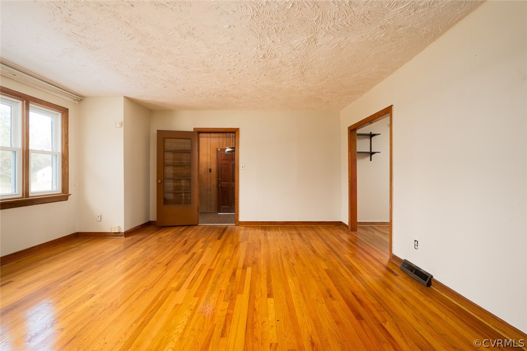 11413 Reedy Branch Road Chesterfield, VA 23838 - Photo 8 of 25 a view of an empty room with wooden floor and a window