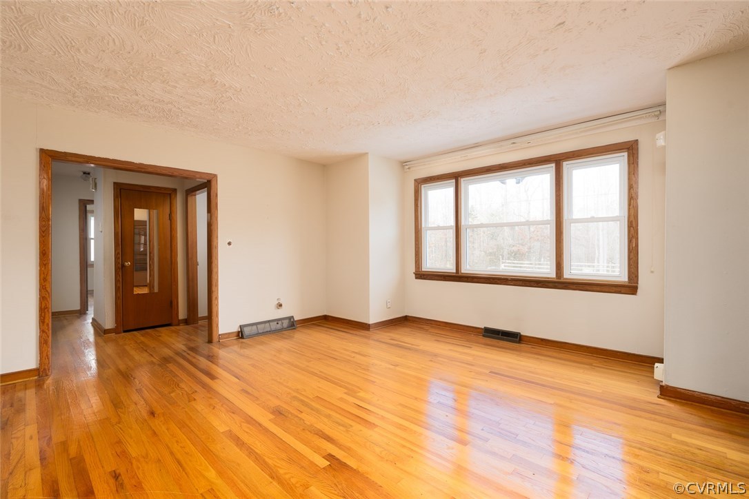 11413 Reedy Branch Road Chesterfield, VA 23838 - Photo 10 of 25 an empty room with wooden floor and windows