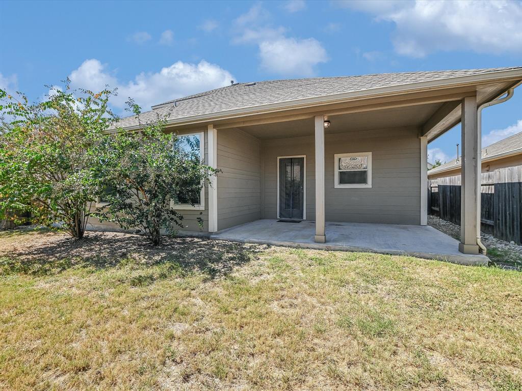 141 Serrano Street Georgetown, TX 78628 - Photo 18 of 19 A private covered patio provides a secluded outdoor retreat with direct access to the interior.