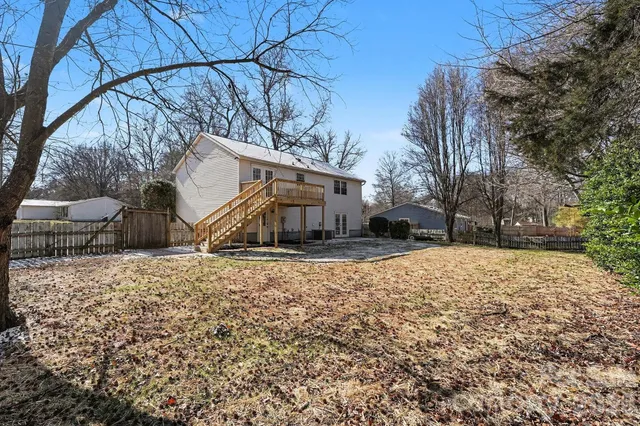 a front view of a house with a yard covered in snow
