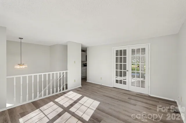 a view of a room with wooden floor and windows