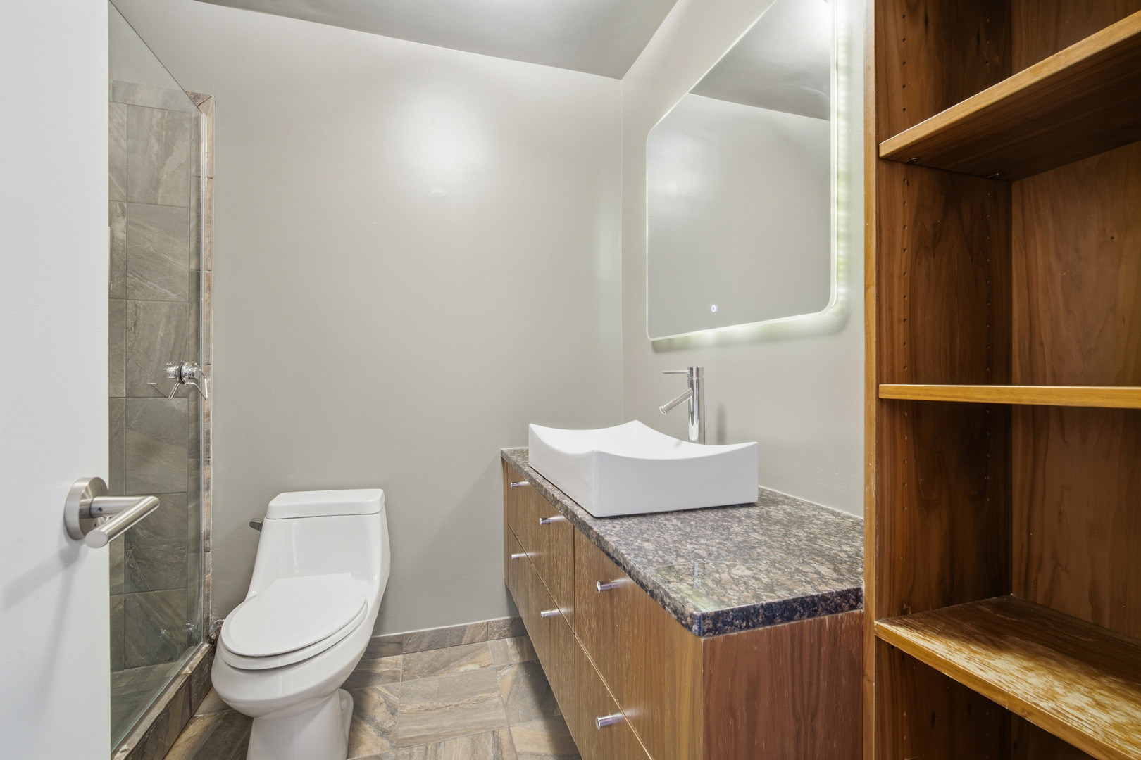 5455 North Sheridan Road, Unit 2611 Chicago, IL 60640 - Photo 16 of 26 a bathroom with a granite countertop sink and a toilet