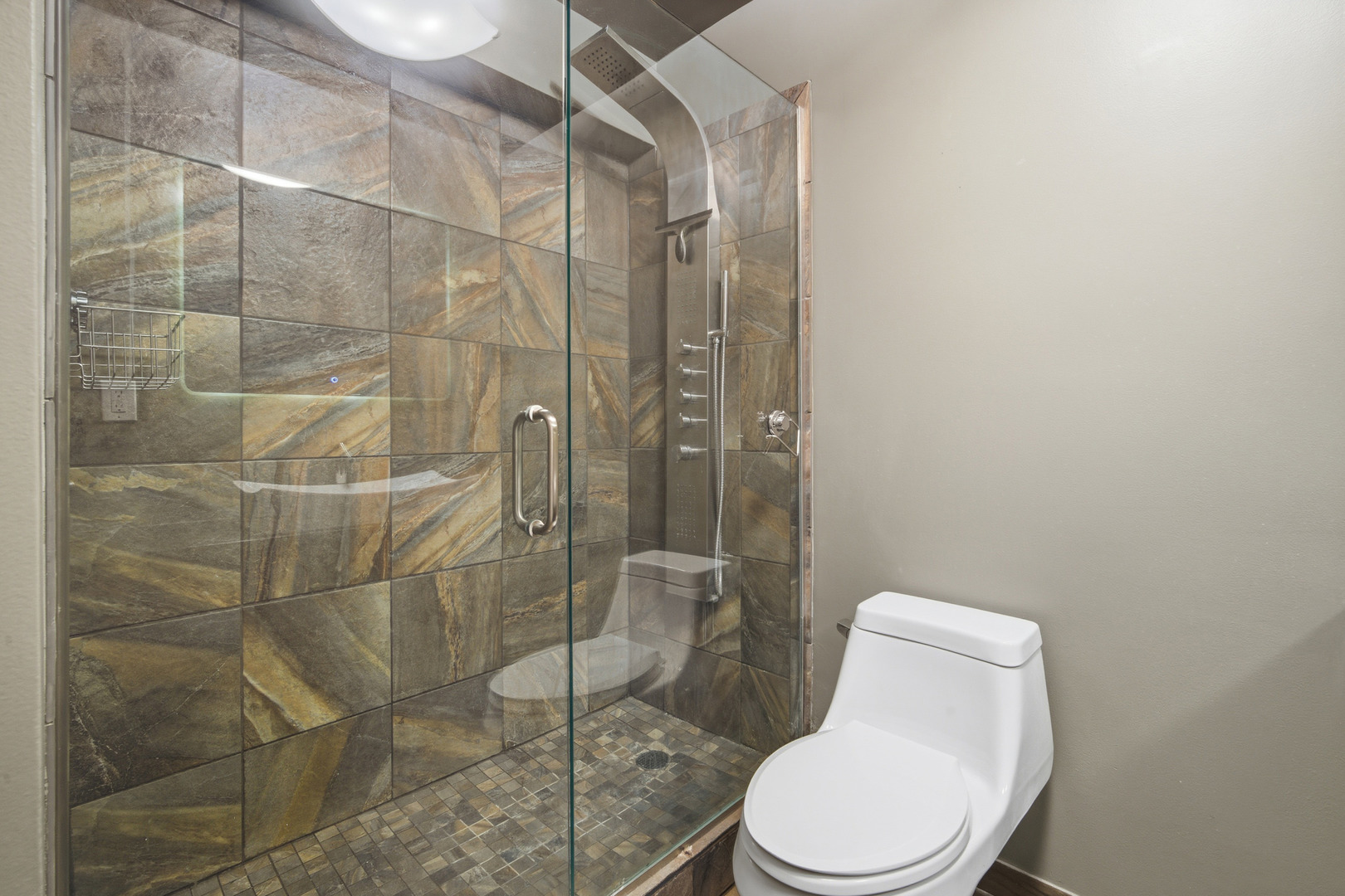 5455 North Sheridan Road, Unit 2611 Chicago, IL 60640 - Photo 17 of 26 a white toilet and shower in a bathroom