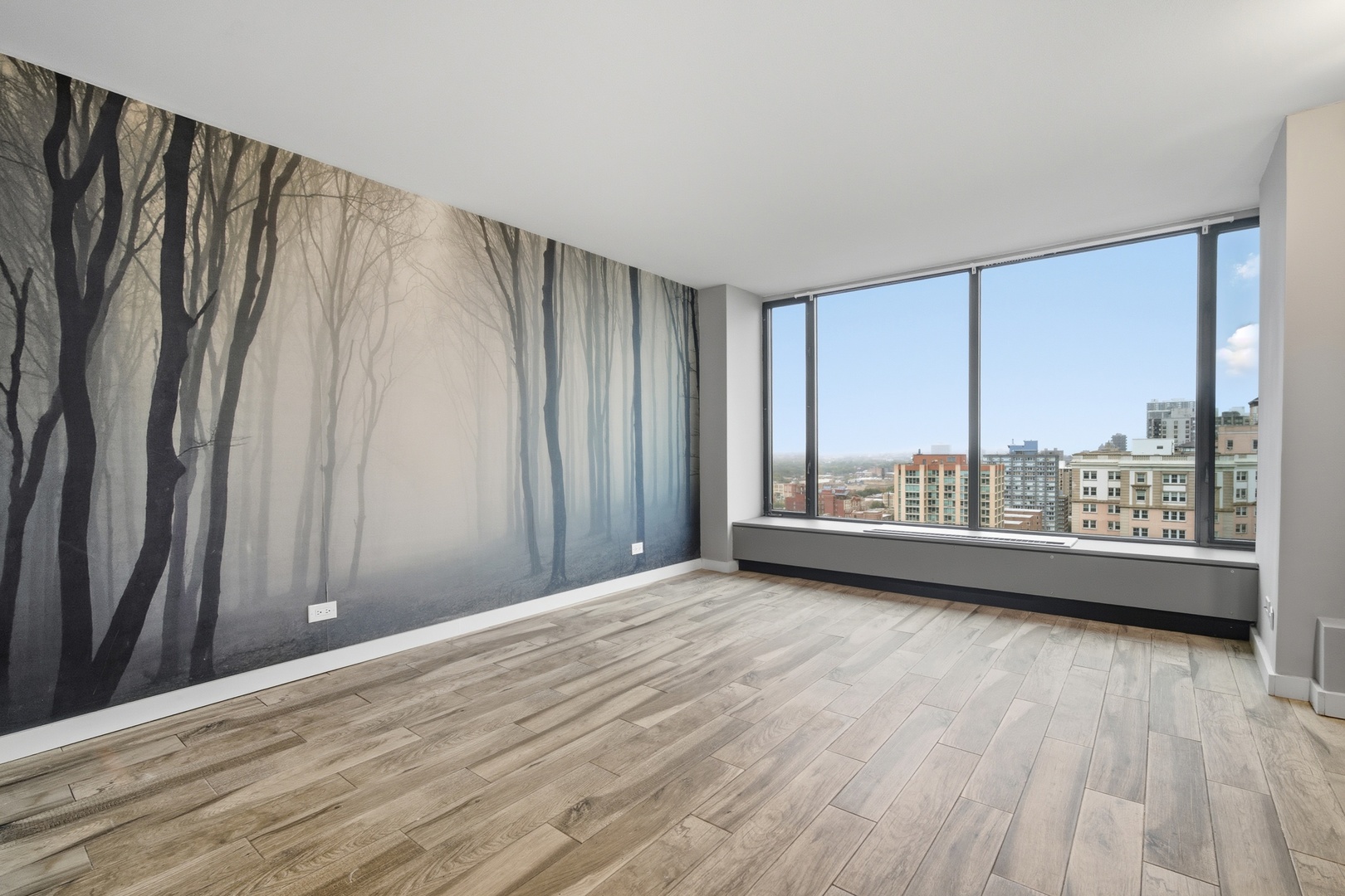 5455 North Sheridan Road, Unit 2611 Chicago, IL 60640 - Photo 19 of 26 a view of a room with wooden floor and large window