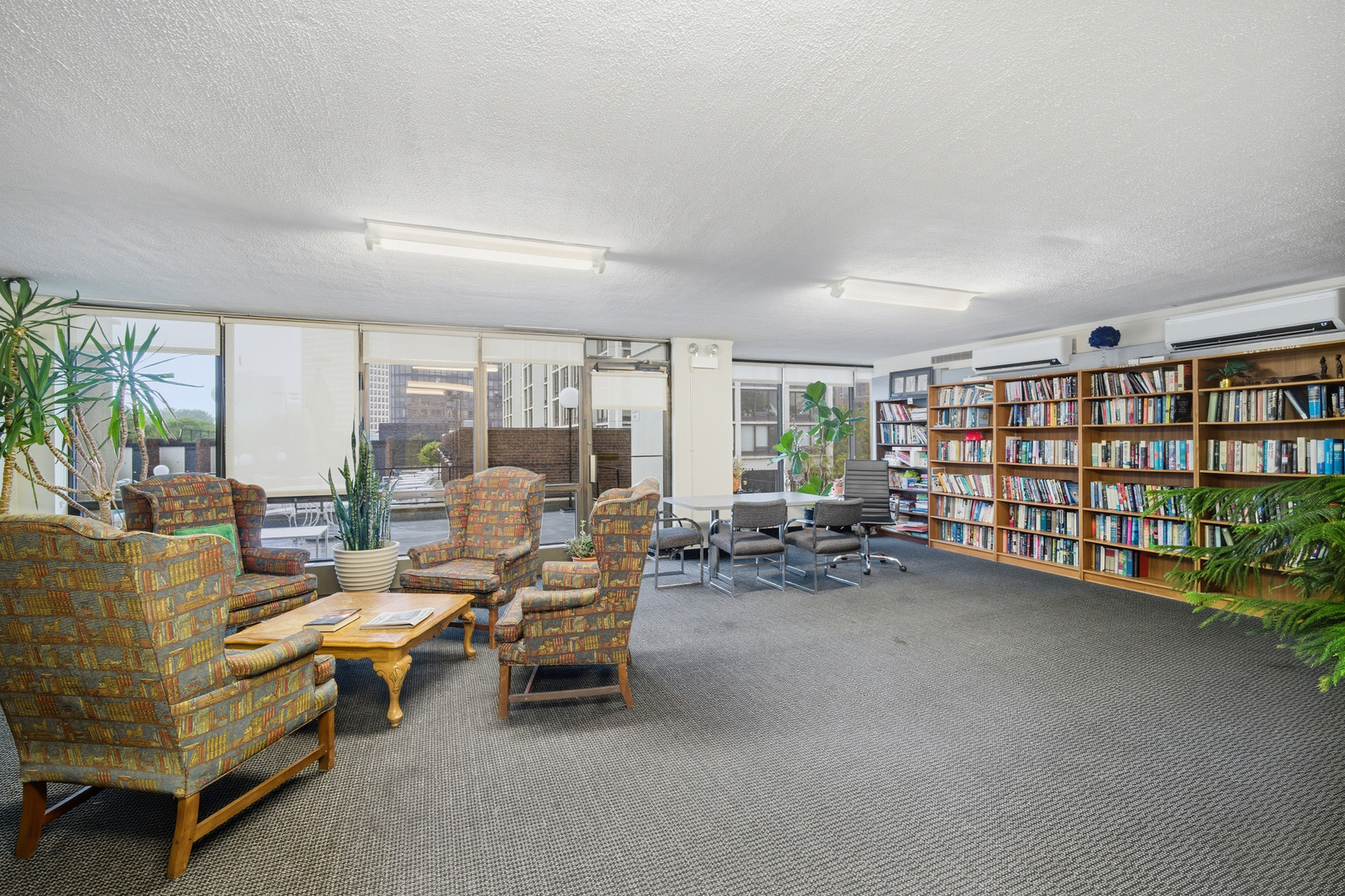 5455 North Sheridan Road, Unit 2611 Chicago, IL 60640 - Photo 22 of 26 a living room with furniture and a book shelf