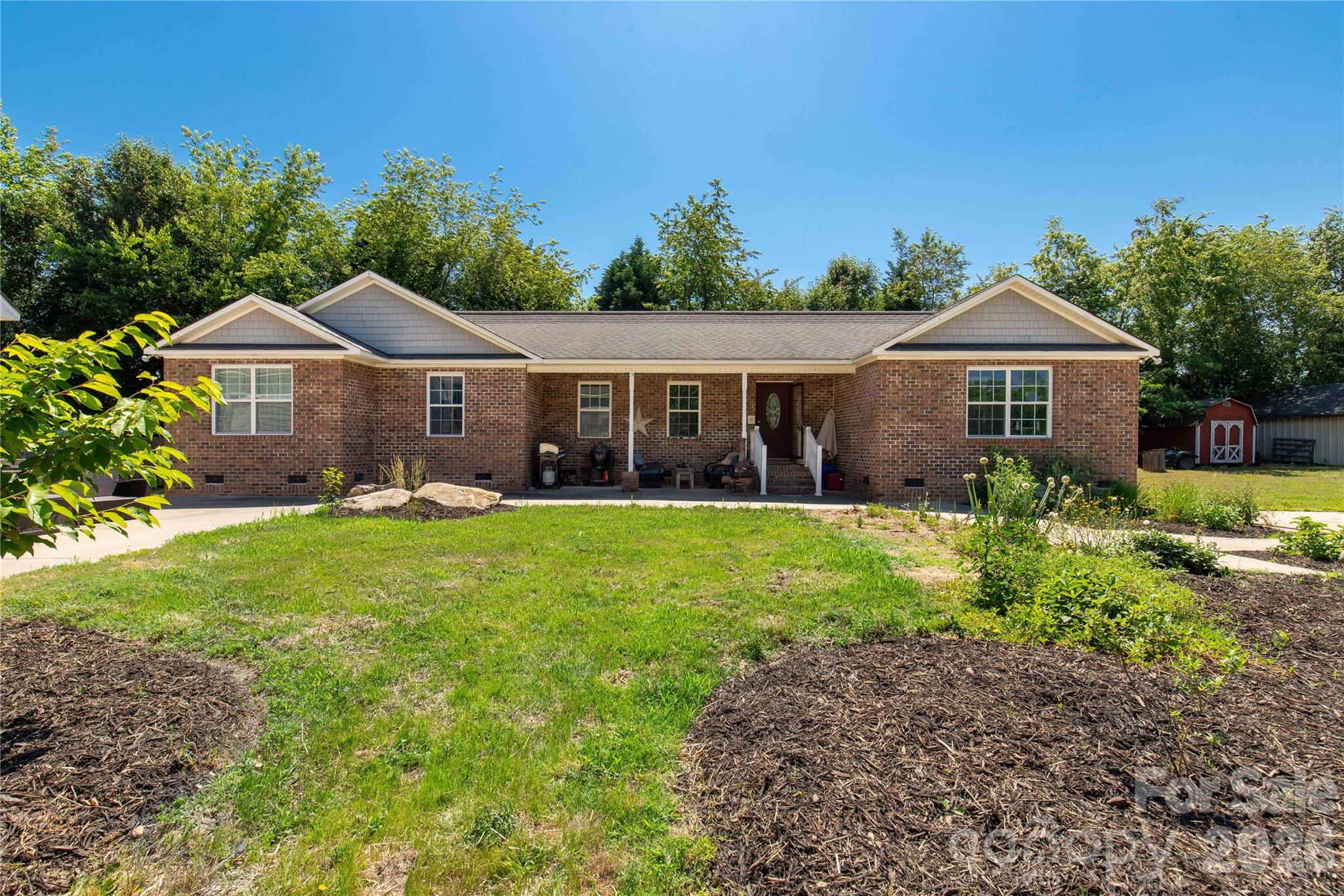 1845 State Rd S-46-149 Clover, SC 29710 - Photo 6 of 28 a front view of a house with garden