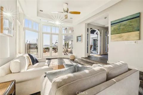 a living room with furniture and a floor to ceiling window