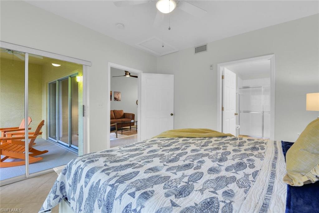 9165 Celeste Drive, Unit 3303 Naples, FL 34113 - Photo 13 of 26 a bedroom with bed and walk in closet