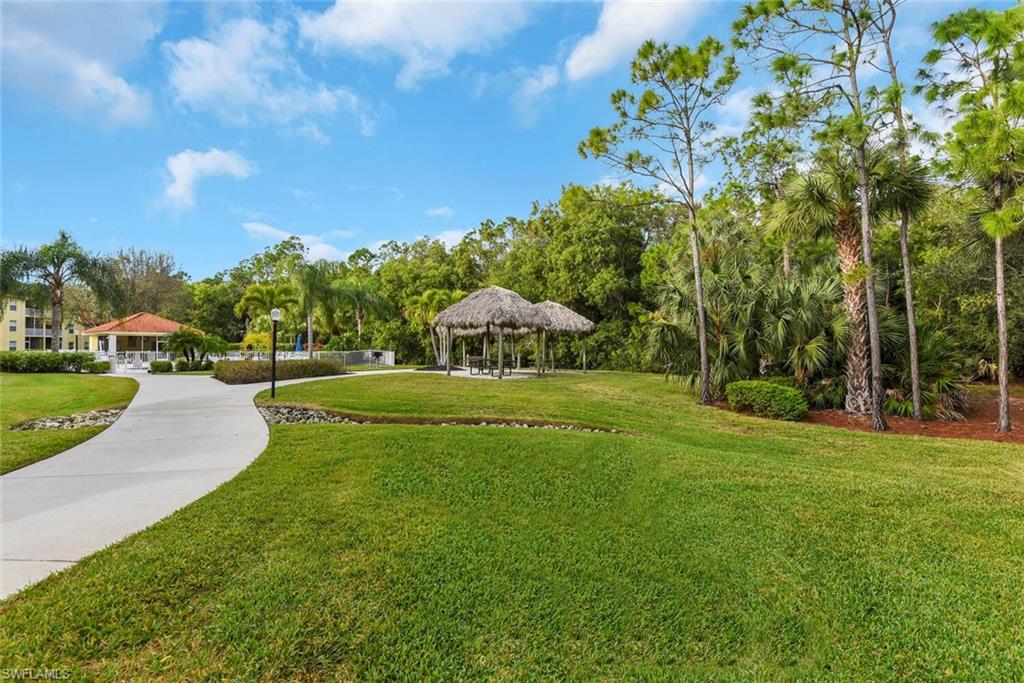 9165 Celeste Drive, Unit 3303 Naples, FL 34113 - Photo 22 of 26 a view of a park with large trees