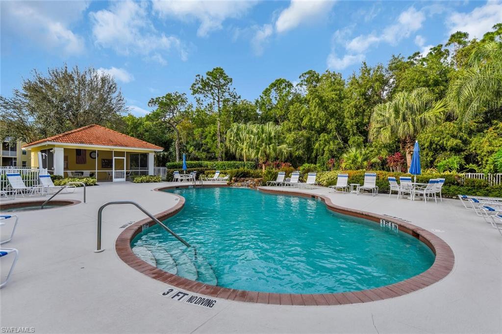 9165 Celeste Drive, Unit 3303 Naples, FL 34113 - Photo 24 of 26 a swimming pool with outdoor seating and yard