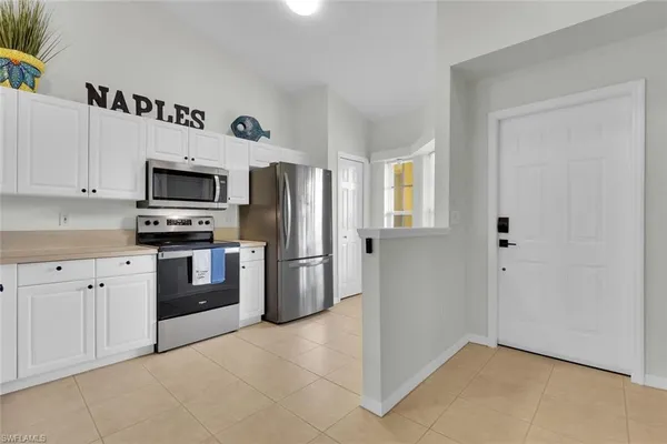 a kitchen with stainless steel appliances a refrigerator stove and microwave