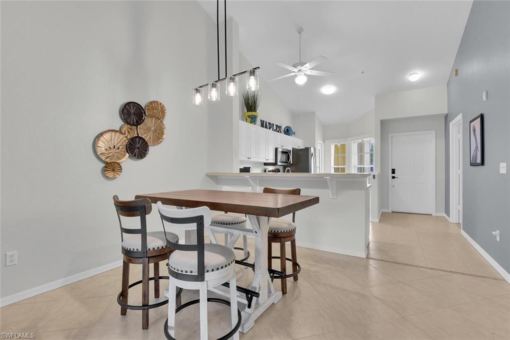 9165 Celeste Drive, Unit 3303 Naples, FL 34113 - Photo 7 of 26 a kitchen with a table and chairs in it
