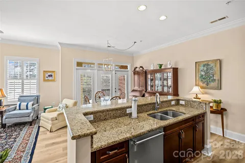 a kitchen with granite countertop a sink and a stove