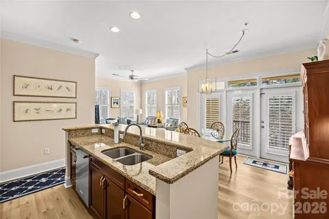 a kitchen that has a sink a stove and a table in it
