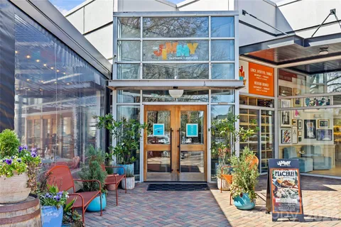 a view of a building with a potted plant ana a small yard