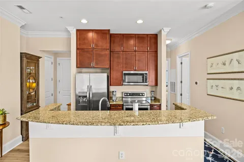 a kitchen with stainless steel appliances granite countertop a granite counter tops and white cabinets