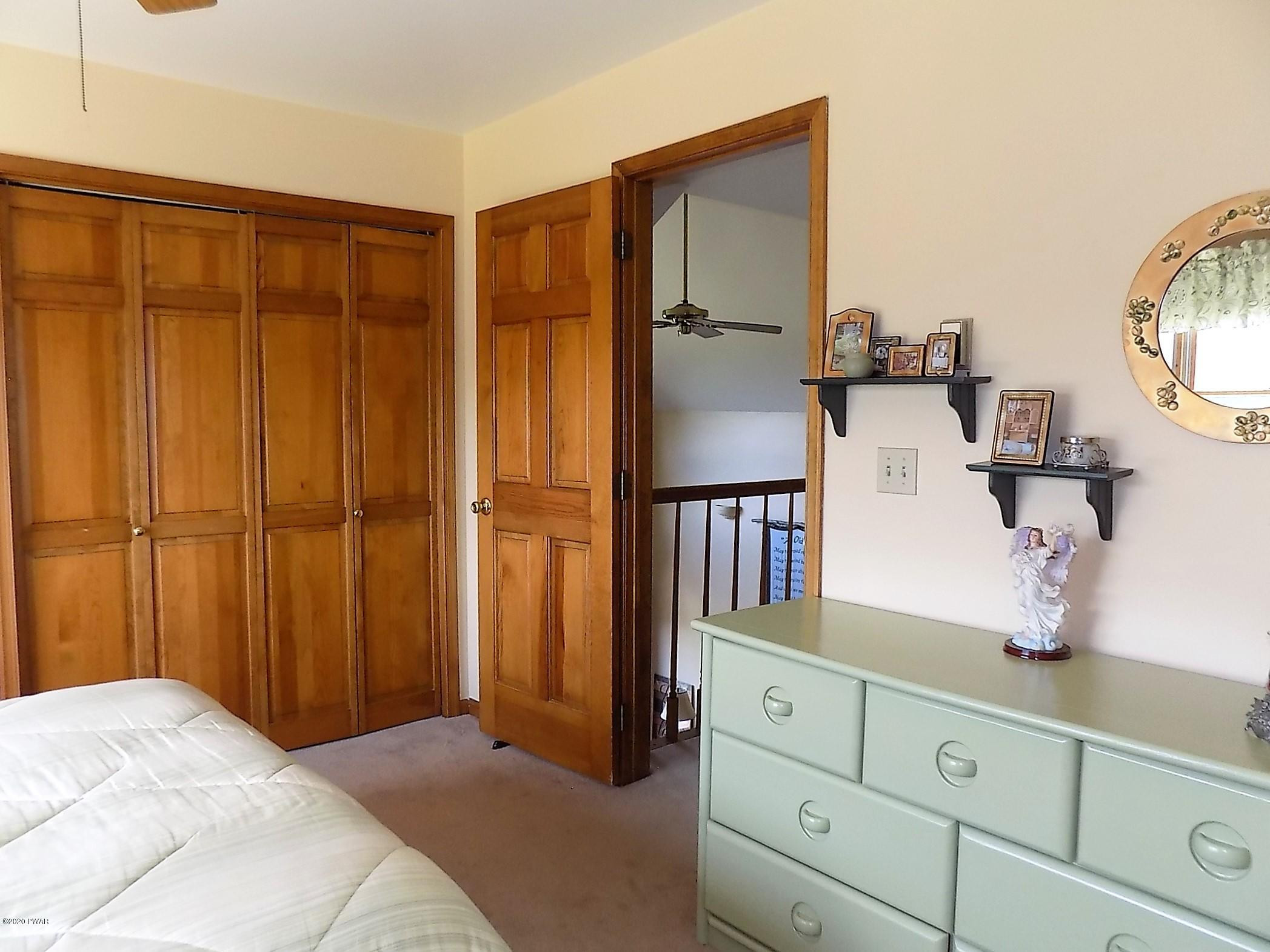 171 Valleyview Road Greentown, PA 18426 - Photo 83 of 111 a bedroom with a bed and a mirror on dresser