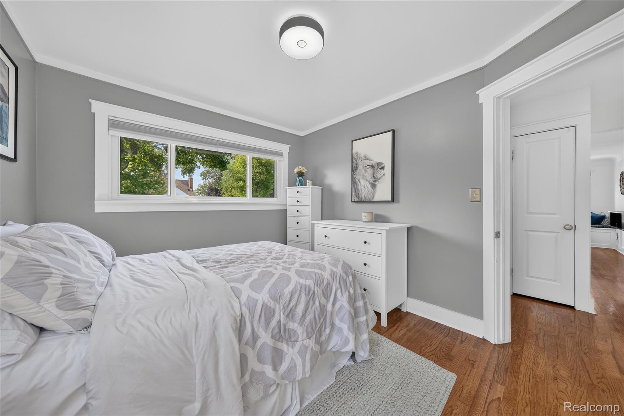 4112 Durham Road Royal Oak, MI 48073 - Photo 20 of 38 Hardwood flooring, crown molding, white trim, recessed lighting fixture, and a multi-pane window