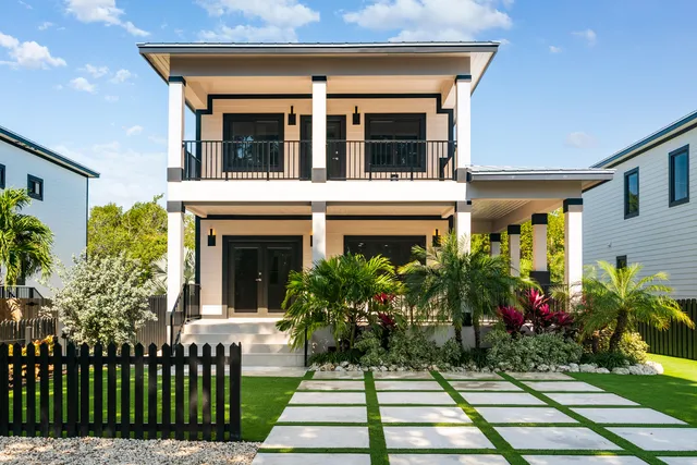 a view of a house with potted plants and a table
