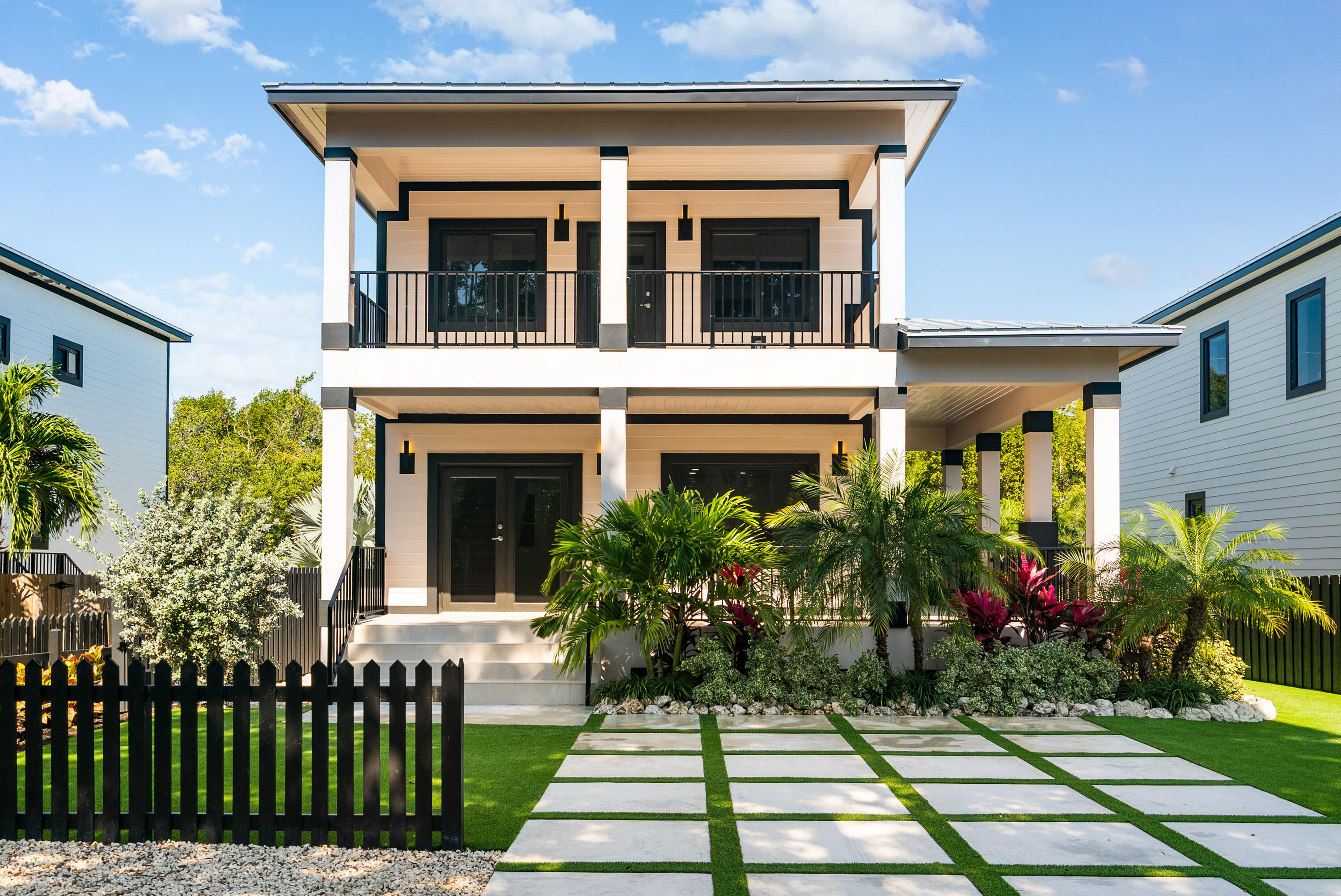 a view of a house with potted plants and a table