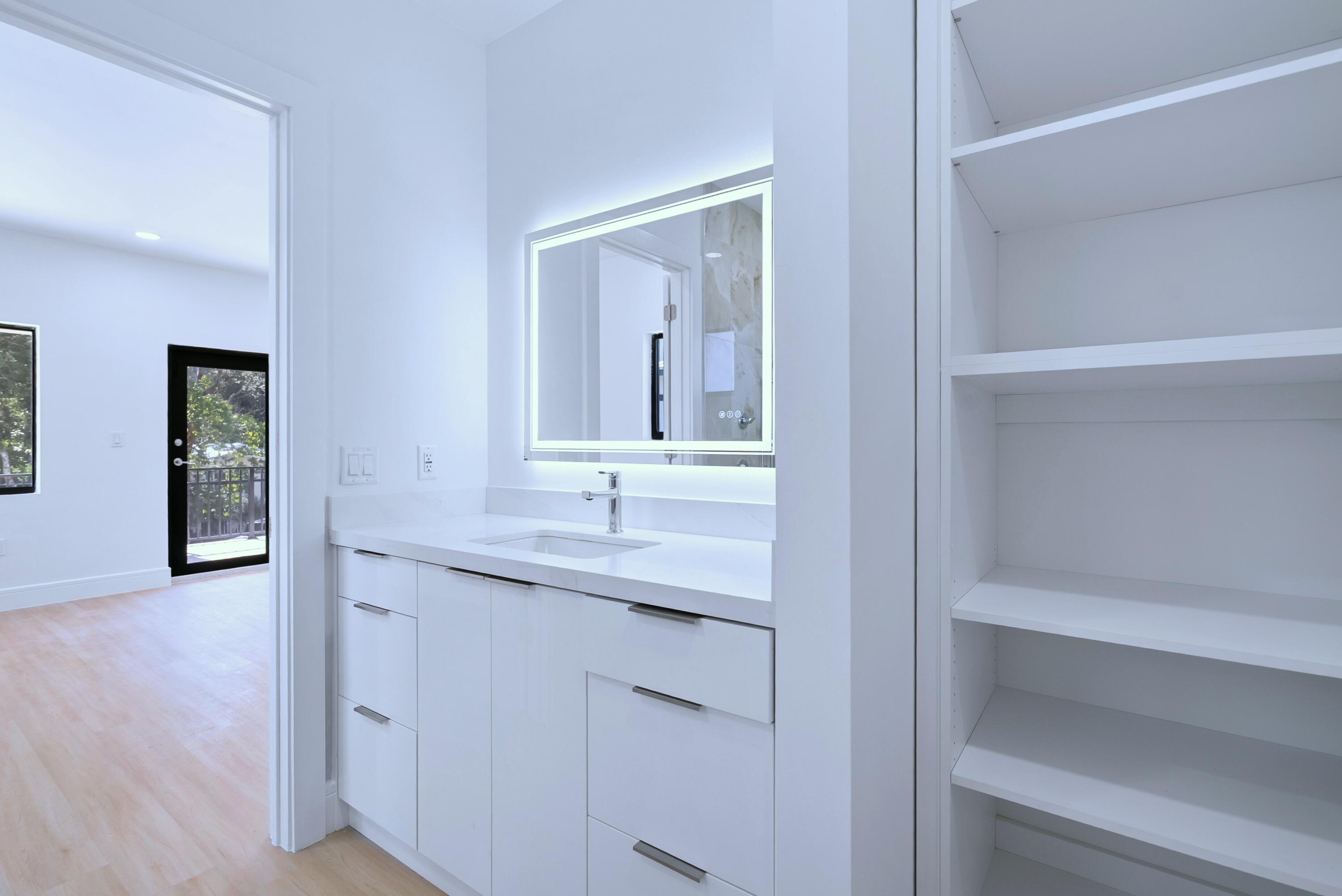 17 Coral Way Key Largo, FL 33037 - Photo 34 of 51 a en suite bathroom with a granite countertop sink and a mirror