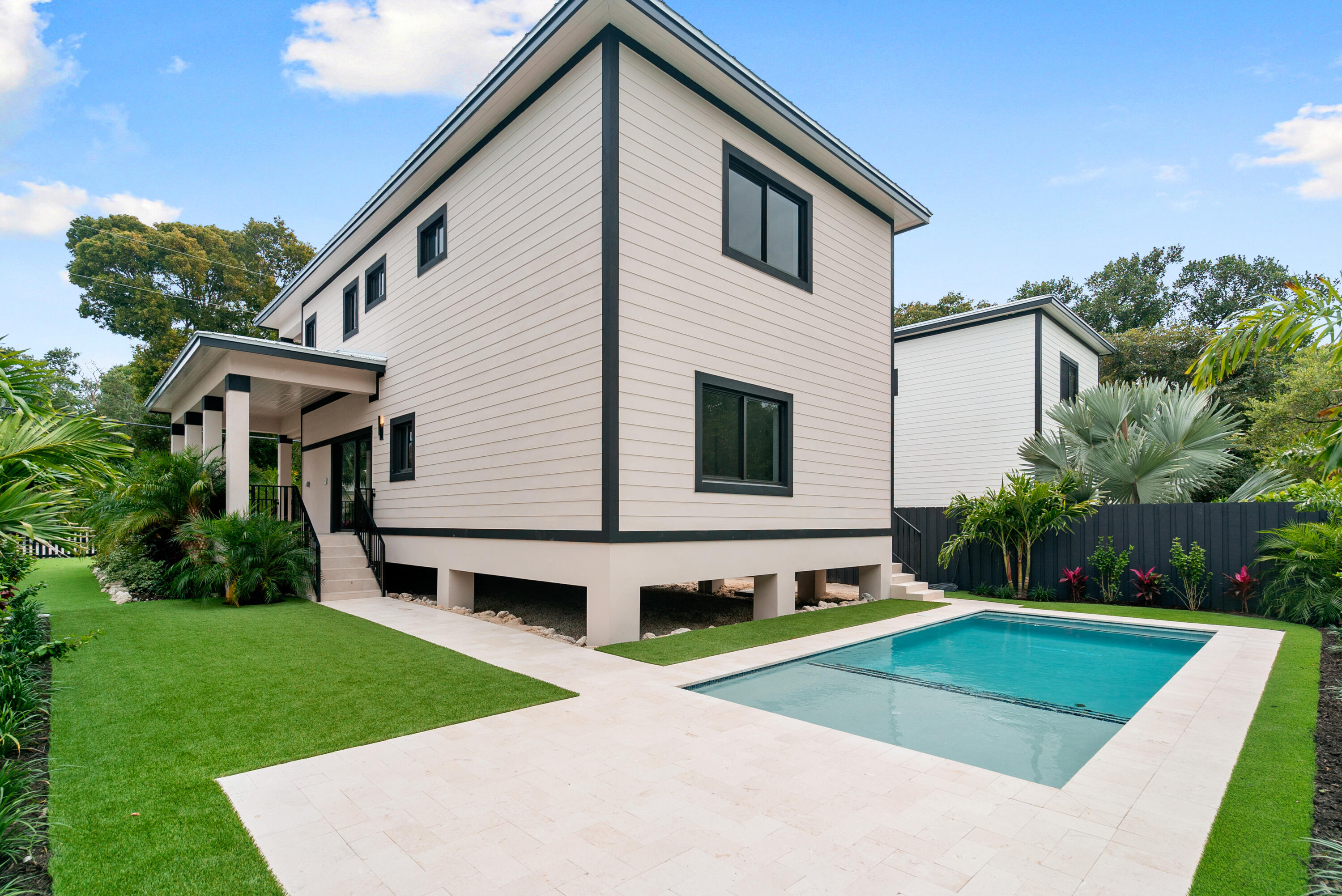 17 Coral Way Key Largo, FL 33037 - Photo 39 of 51 a view of a white house with a yard
