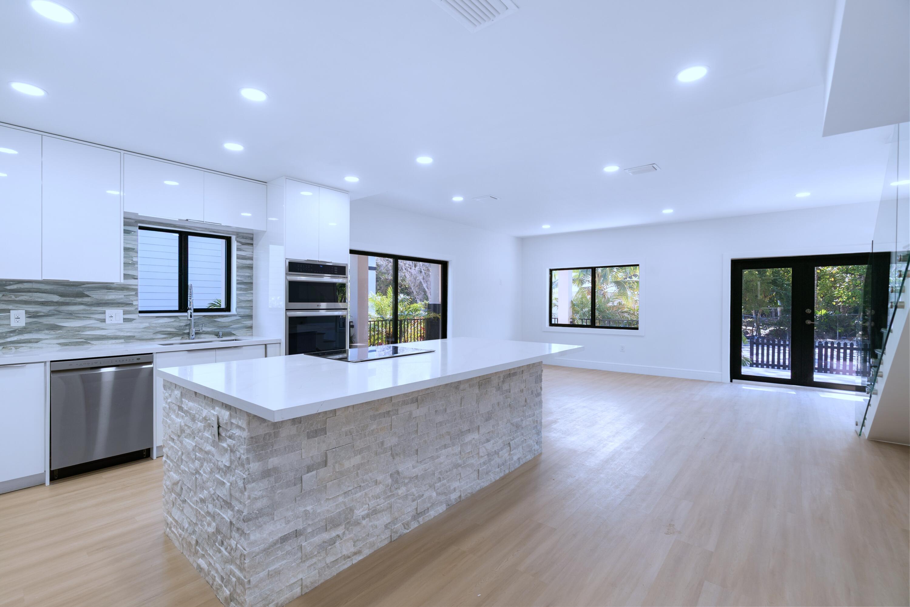 17 Coral Way Key Largo, FL 33037 - Photo 10 of 51 a large kitchen with stainless steel appliances granite countertop a large counter top and a wooden floors