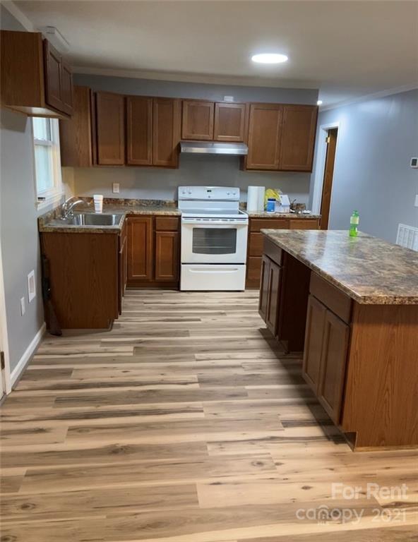 107 Keeter Street Grover, NC 28073 - Photo 2 of 9 a kitchen with granite countertop a stove top oven and cabinets