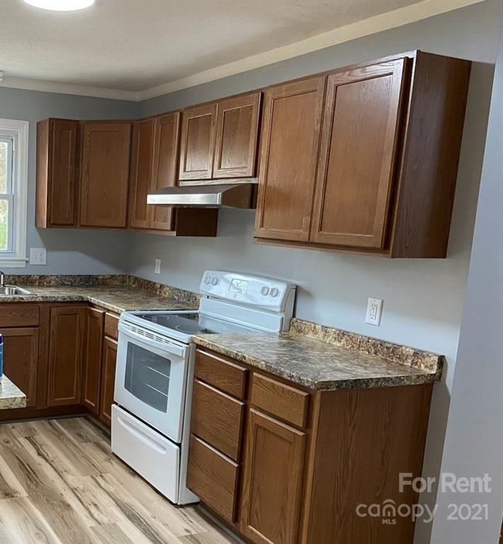 107 Keeter Street Grover, NC 28073 - Photo 3 of 9 a kitchen with granite countertop wood cabinets and stainless steel appliances