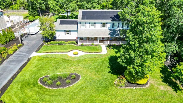 a view of house with backyard outdoor seating and green space