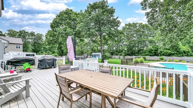 a view of a deck with furniture and trees