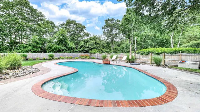 a view of a swimming pool with a yard