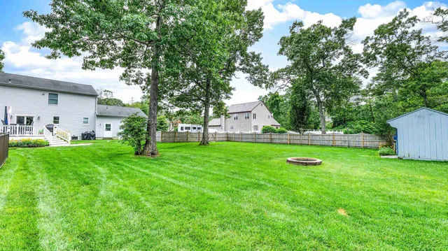 a view of yard with swimming pool and green space