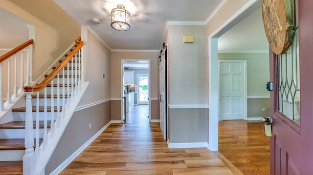 a view of entryway and hall with wooden floor