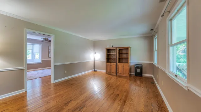 wooden floor in an empty room with a window