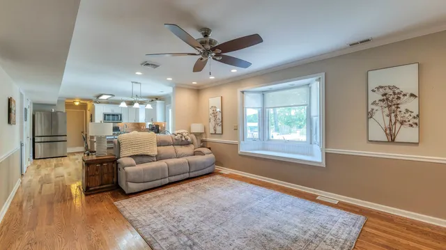 a living room with furniture and a large window