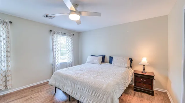 a bedroom with a bed and a window