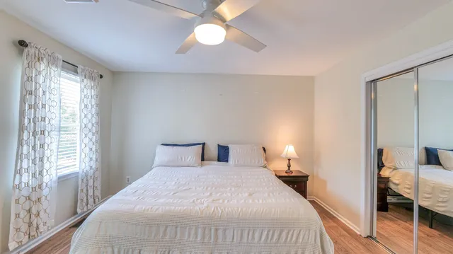 a bedroom with a bed and a chandelier