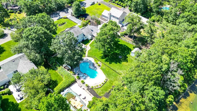 an aerial view of a house with a yard and swimming pool
