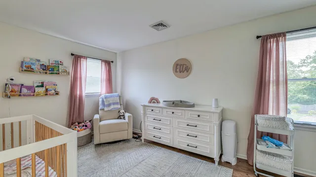 a bedroom with furniture and a window