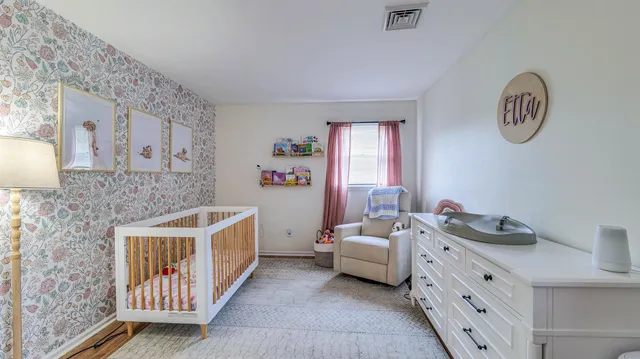 a bathroom with double vanity sink and a window