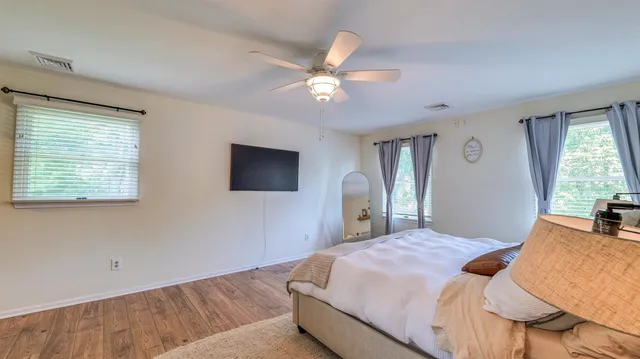 a bedroom with a bed and a chandelier