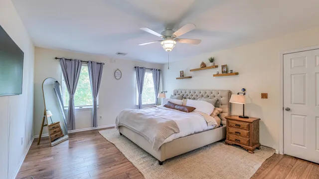 a bedroom with a bed and a chandelier