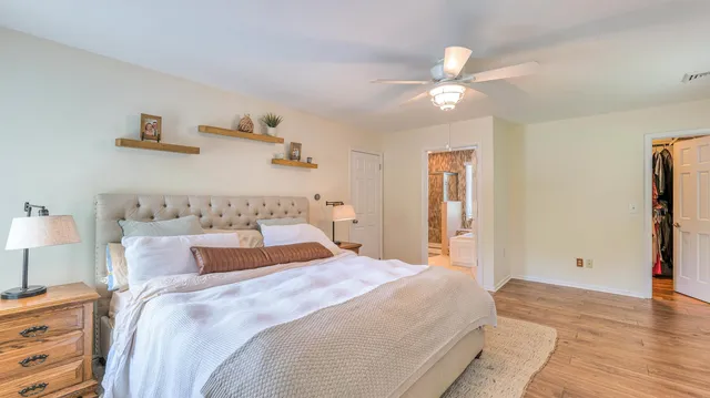 a bedroom with a large bed and a chandelier