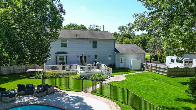 a view of house with backyard outdoor seating and green space