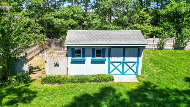 a view of house with a yard