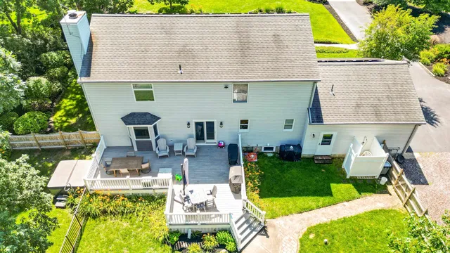 an aerial view of a house with swimming pool and patio