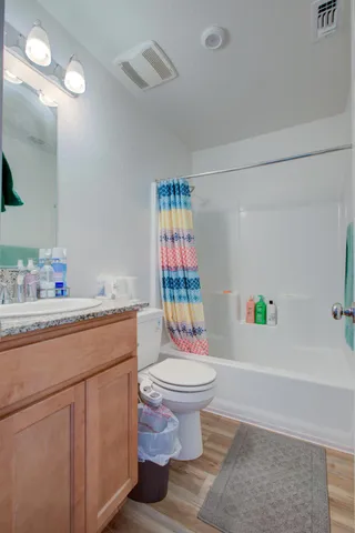 a bathroom with a sink toilet and shower