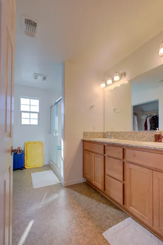 a spacious bathroom with a double vanity sink and a mirror